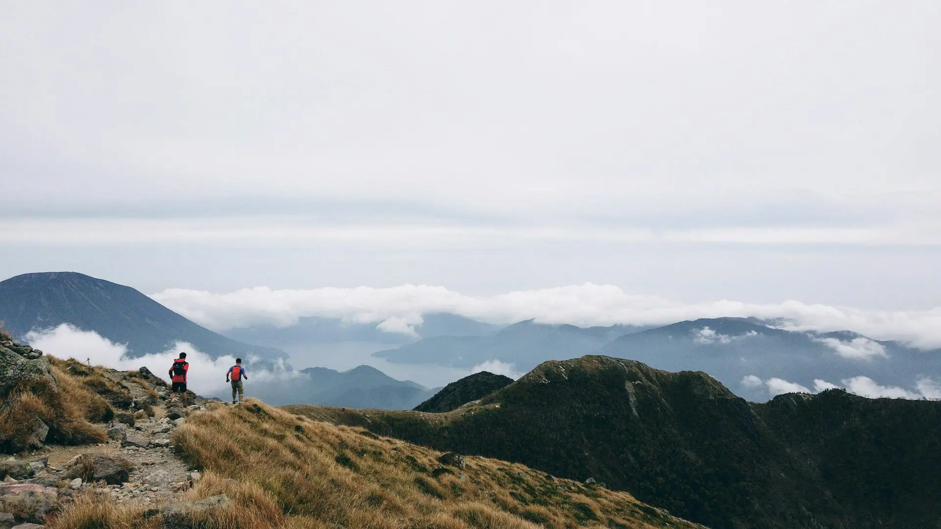 People running across a highland landscape