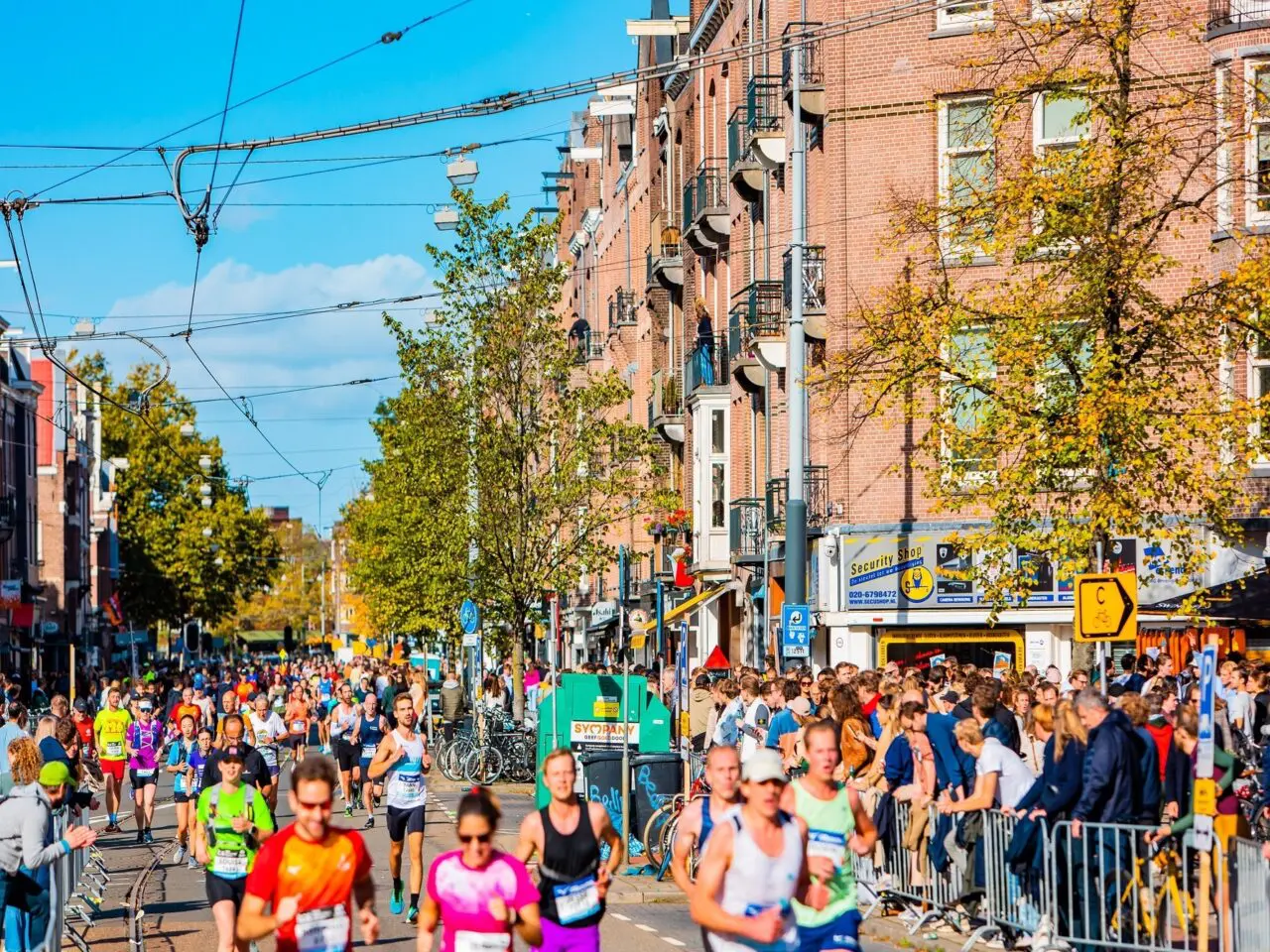 Runners racing through the historic streets of Amsterdam during the Amsterdam Marathon